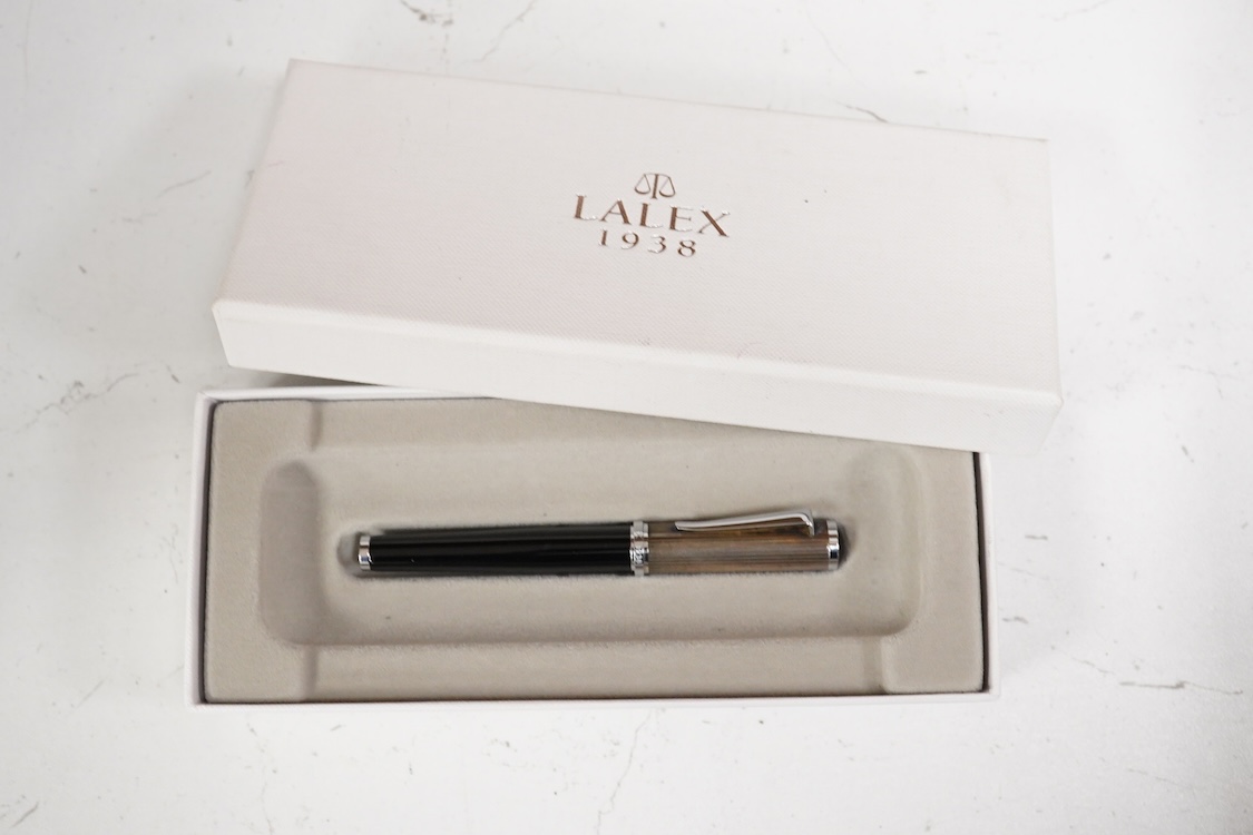 A group of five fountain pens and ballpoint pens